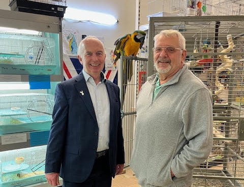 Leader of the Council, Councillor Barry Lewis with Roger the parrot at Pet's Place.