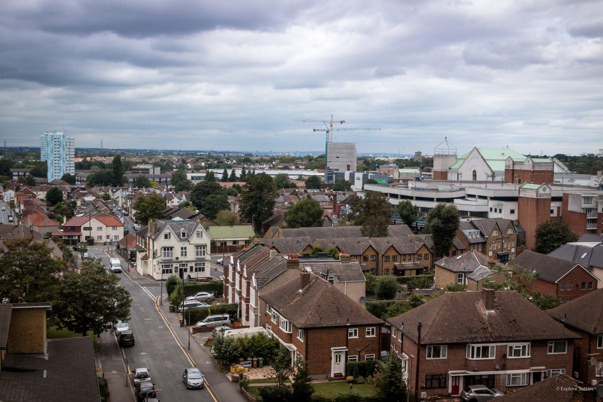 Aerial view of Sutton showing houses, cars in streets and construction work taking place