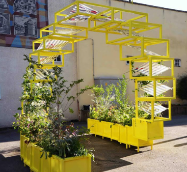 Moon Bloom sculpture - a yellow coloured metal sculpture with flowers inside yellow boxes in Sutton High Street.