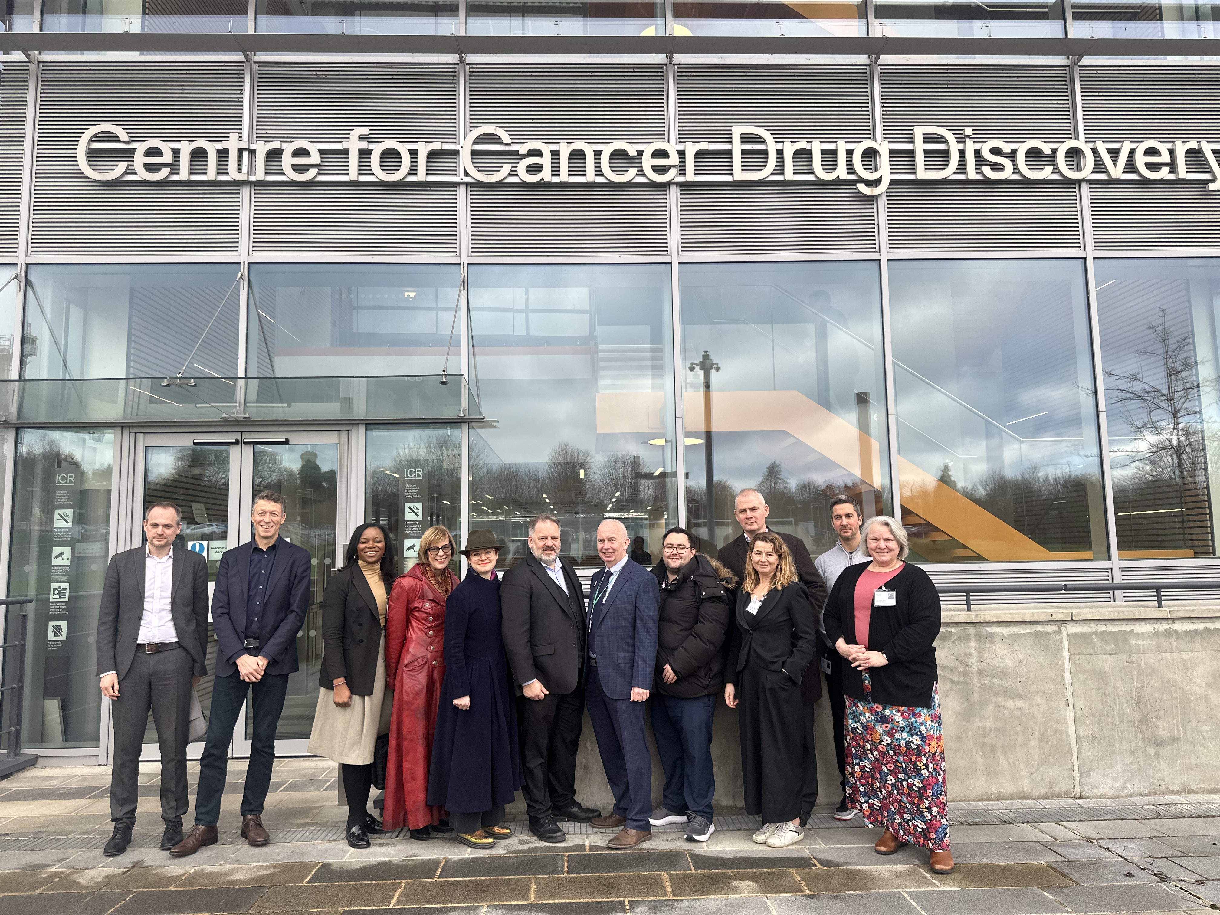 Cllr Barry Lewis, Leader of Sutton Council, Helen Bailey, Chief Executive, Sutton Council, Cllr Jake Short, Richard Simpson, Strategic Director of Resources, Sutton Council and other representatives from Sutton Council, Aviva, and London Cancer Hub outside the London Cancer Hub building in Belmont, Sutton.