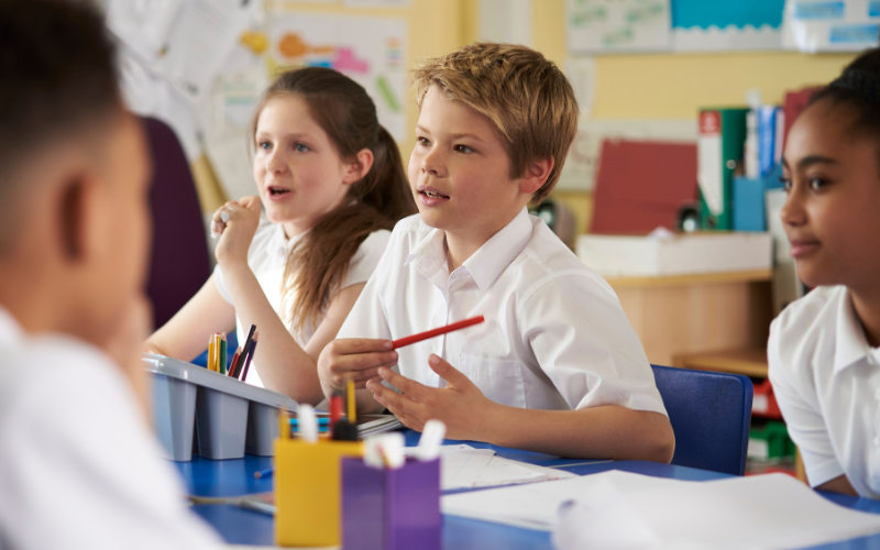 Children sitting at a desk in a classroom