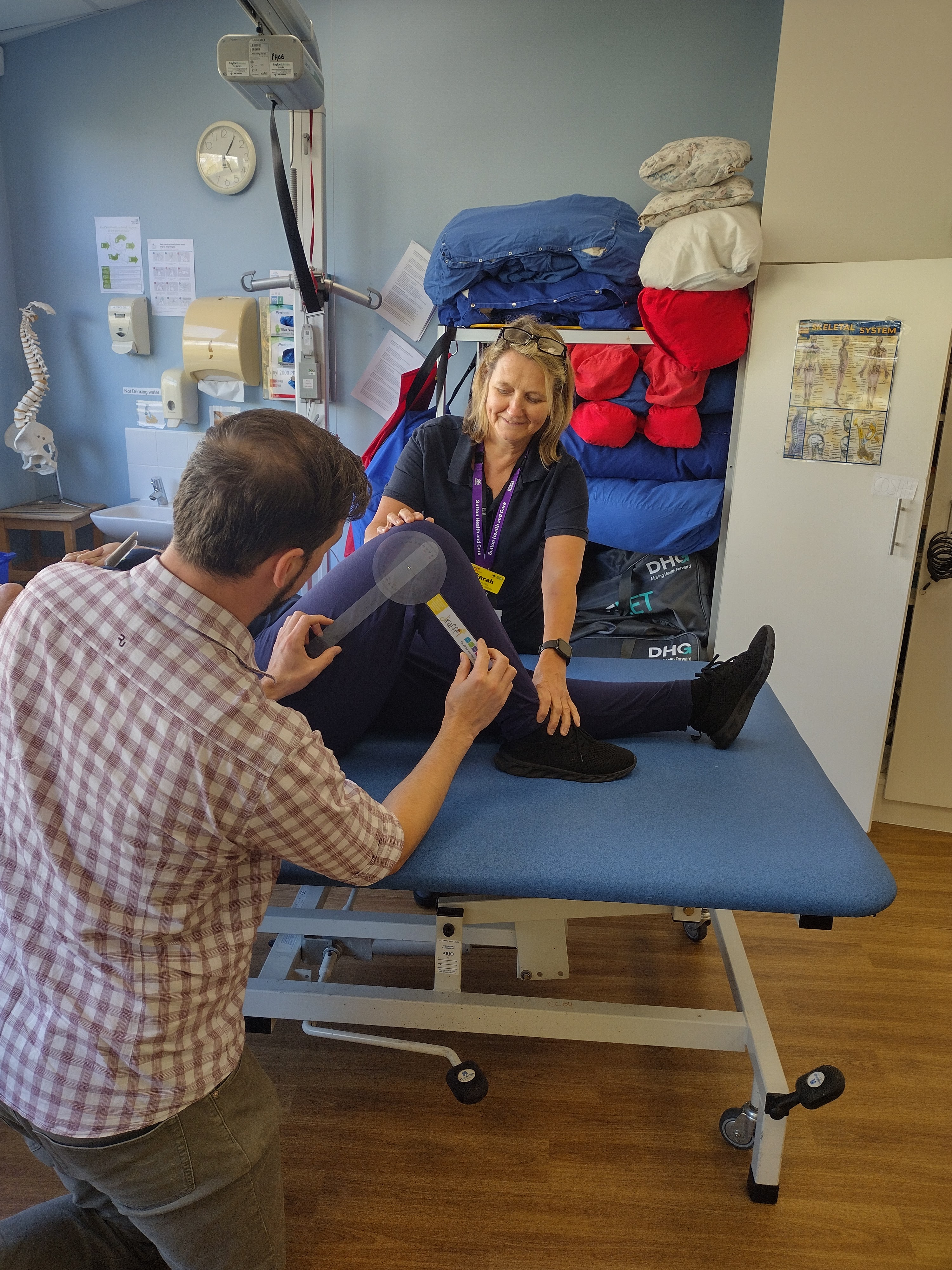 Dan and a health professional supporting a resident at the postural clinic.